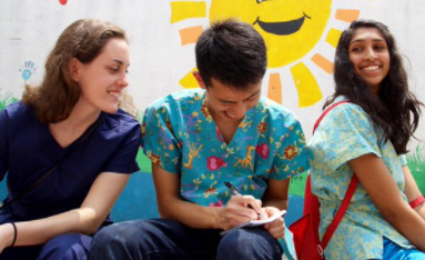 Students discussing and taking notes, laughing with each other