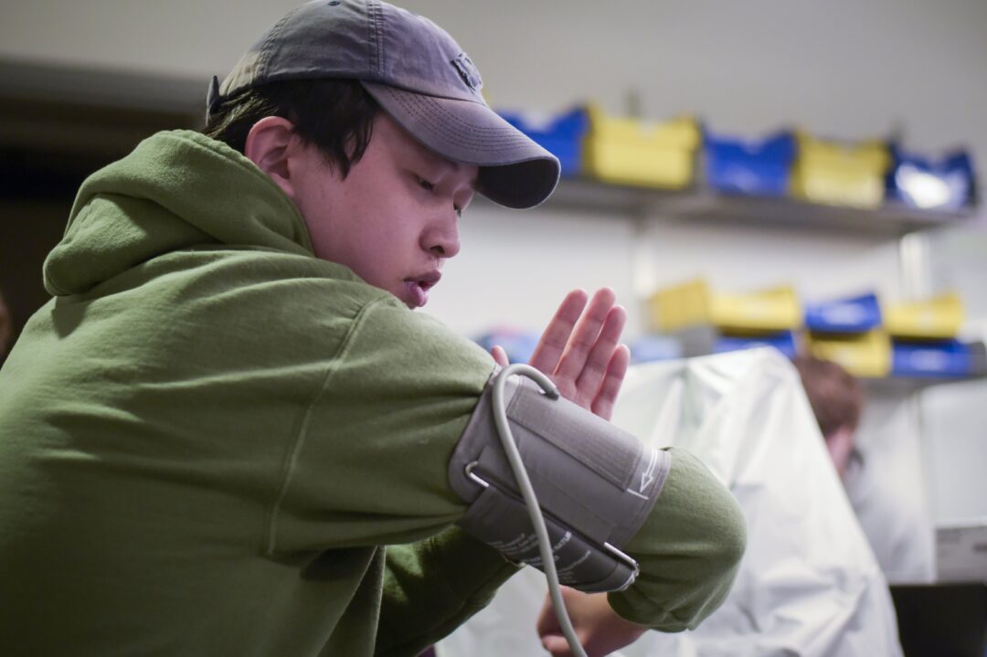 student measuring their blood pressure