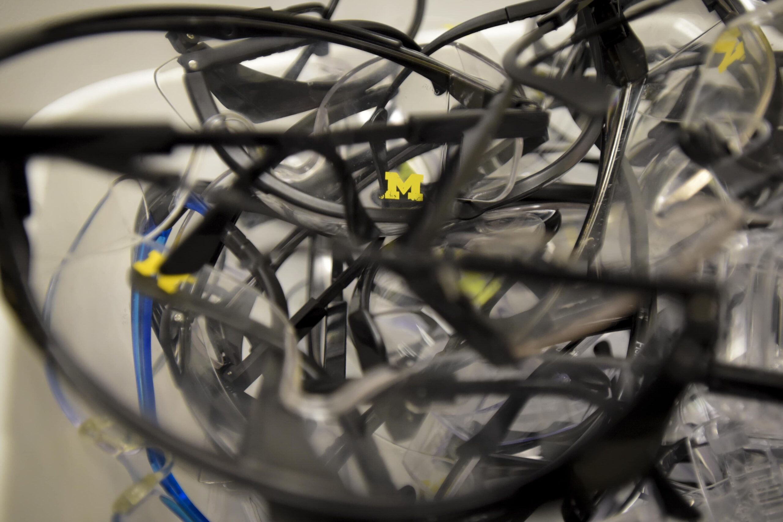 Container of safety goggles with 'M' Logo