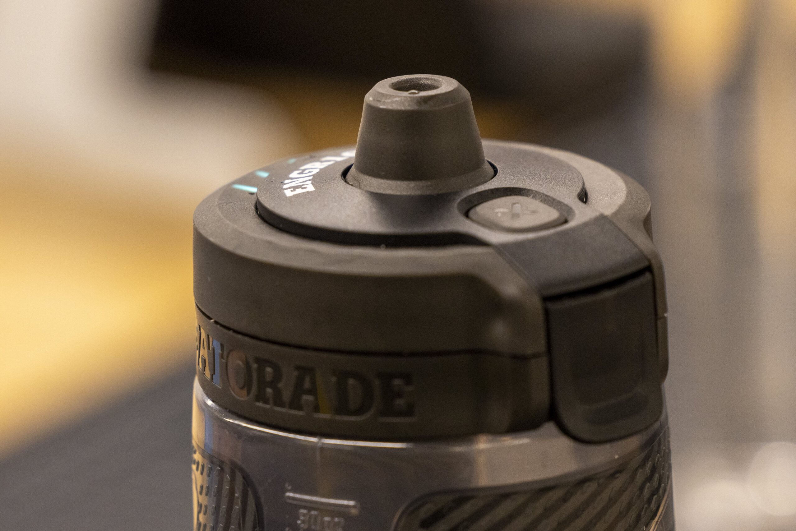 Two students in background looking at someone holding a test tube