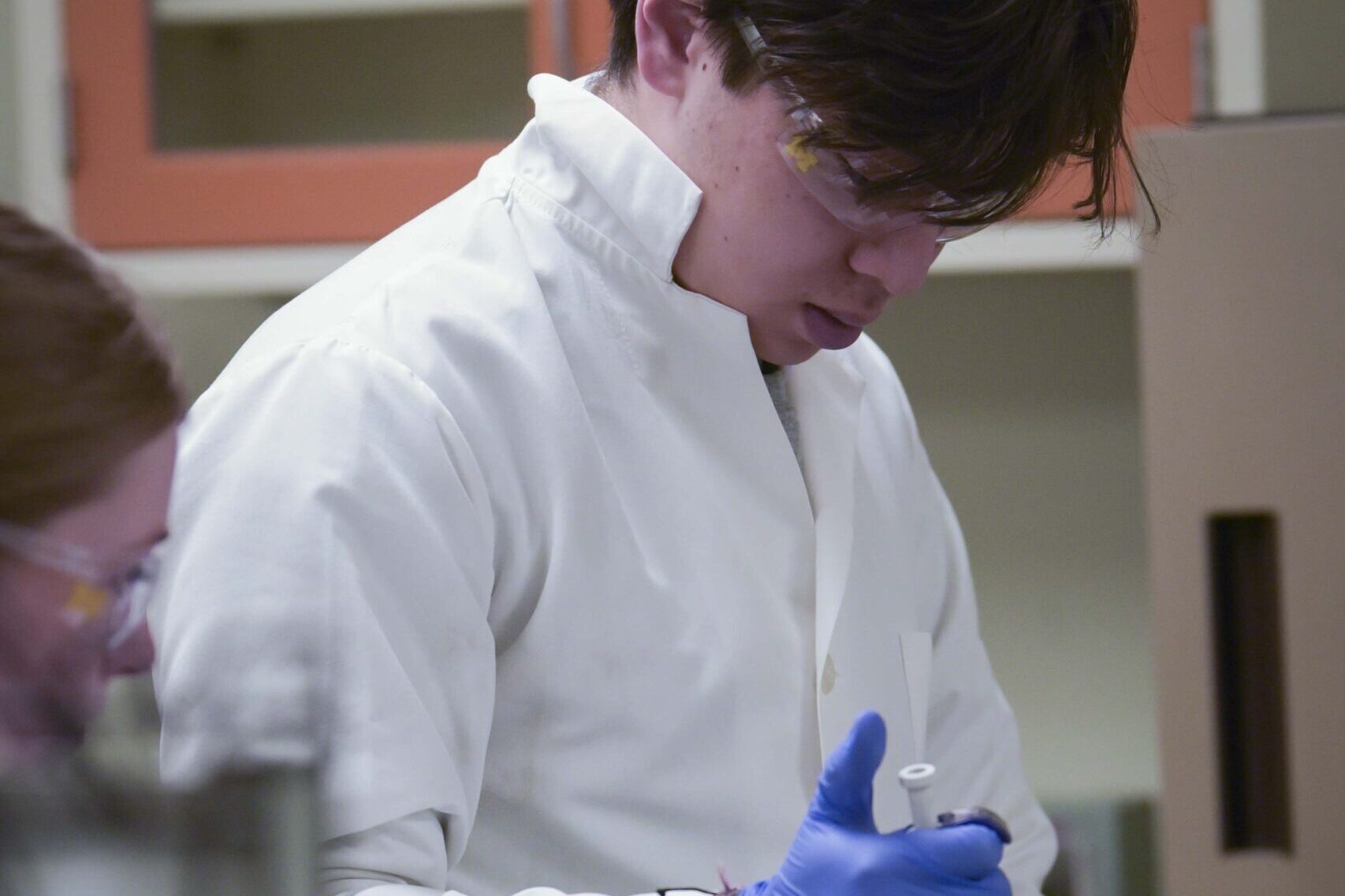 Drawing of a robot holding sign that says “I love ENGR 100” on whiteboard