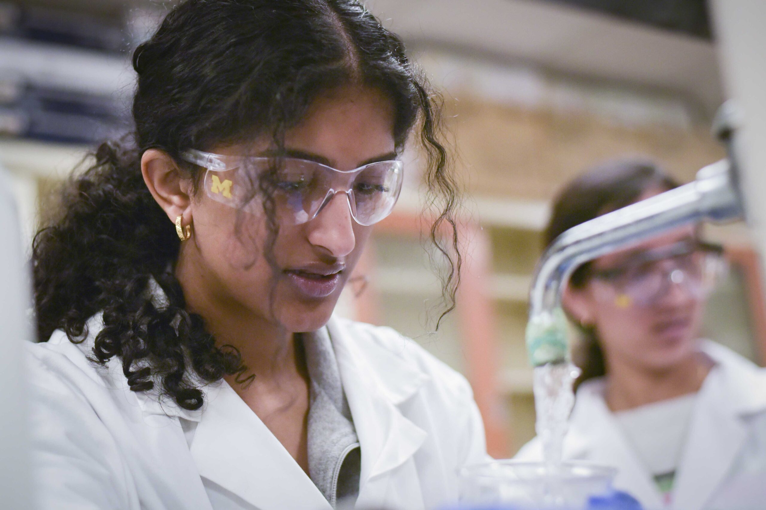 Black toolbox filled with colorful parts on table in front of classroom