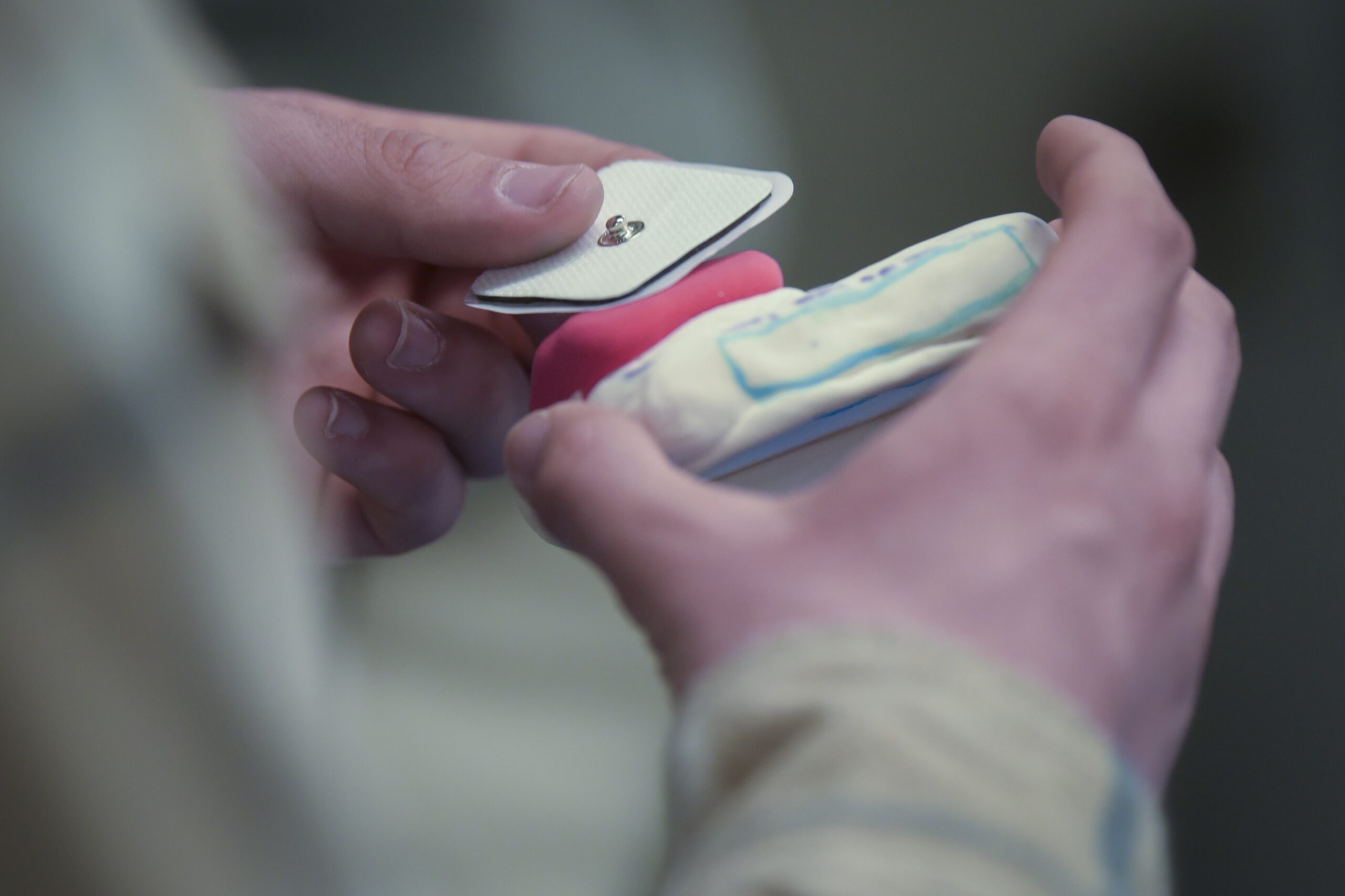 Black toolbox filled with colorful parts on table in front of classroom