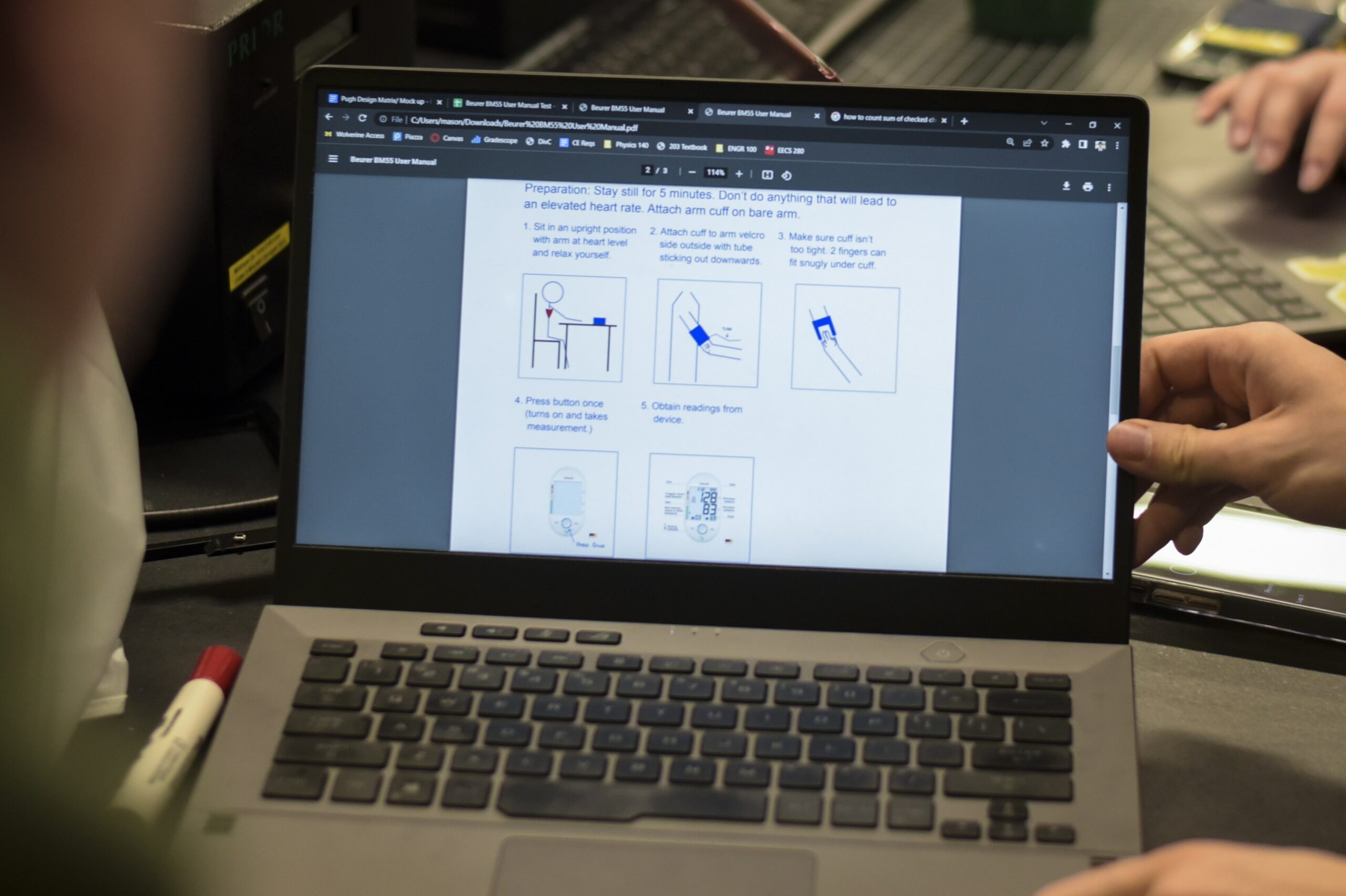 Drawing of a robot holding sign that says “I love ENGR 100” on whiteboard