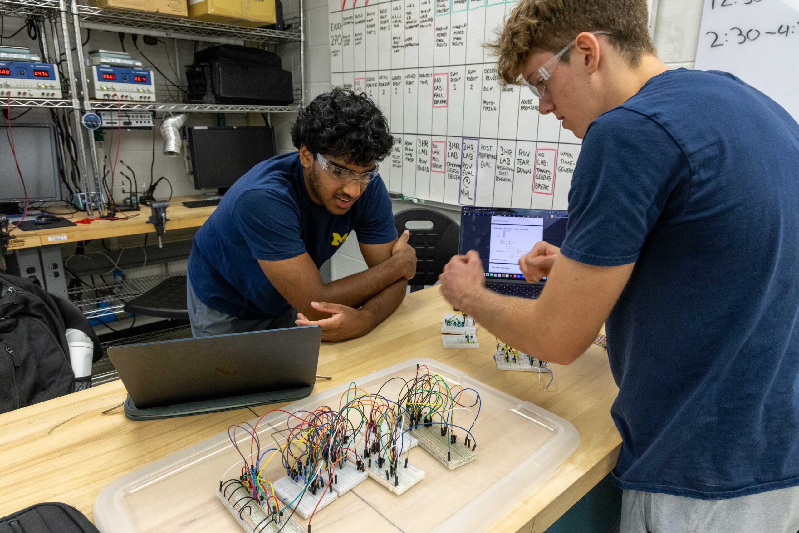 three students testing lab equipment