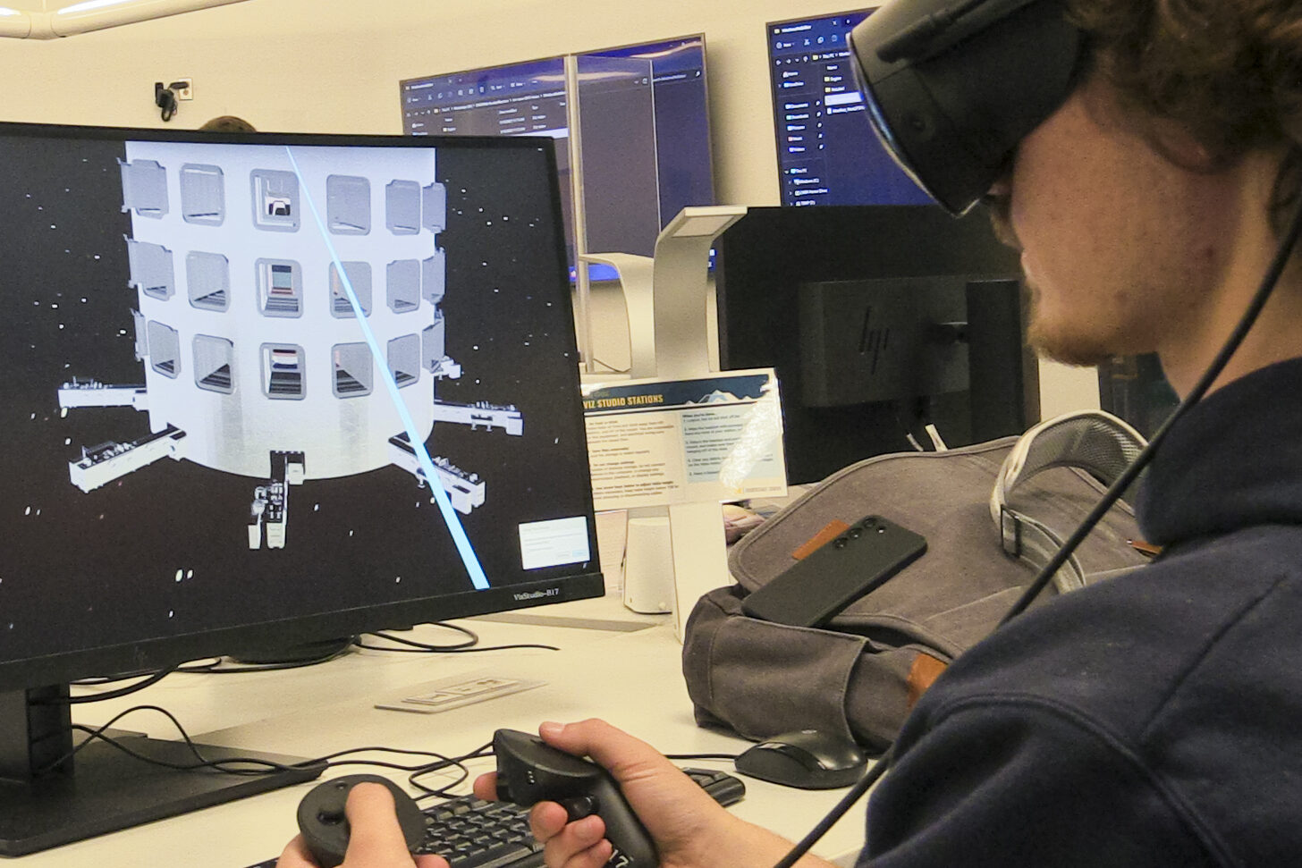 three students testing lab equipment