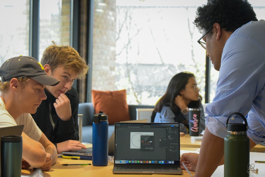 three students working on experiment in lab