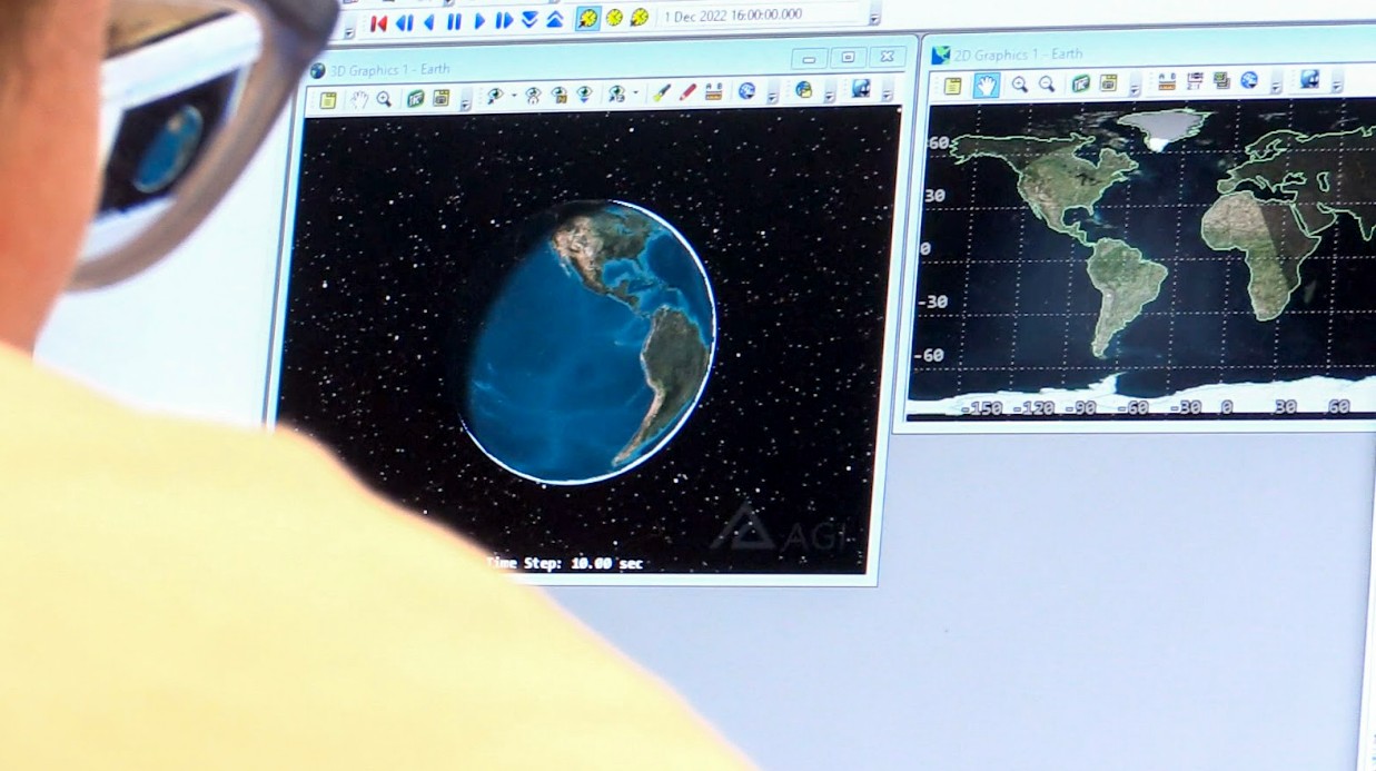 Instructor and three students working on circuit board together